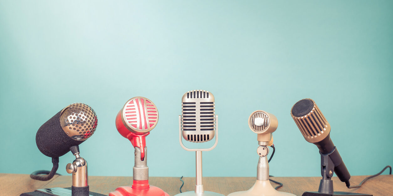 Retro old microphones for press conference or interview on table. Vintage style filtered photo