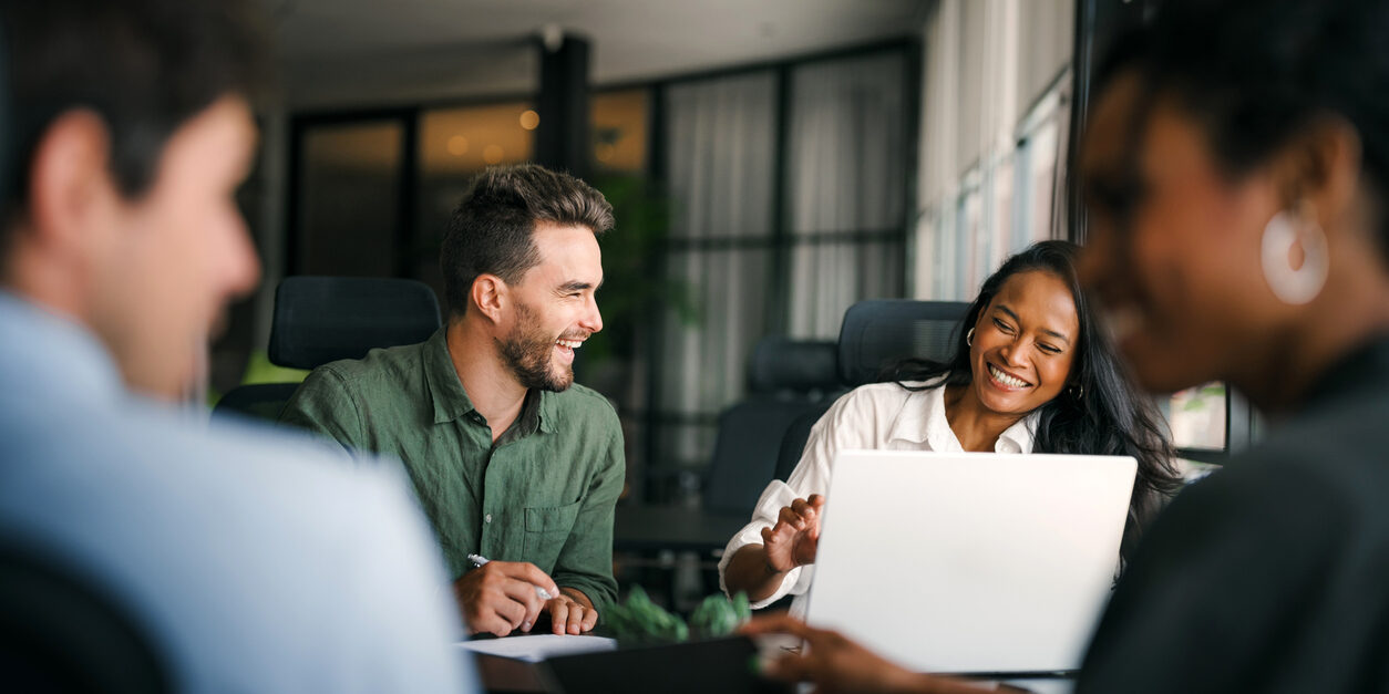 Group of young multi-ethnic startup business team collaborating on project in modern office
